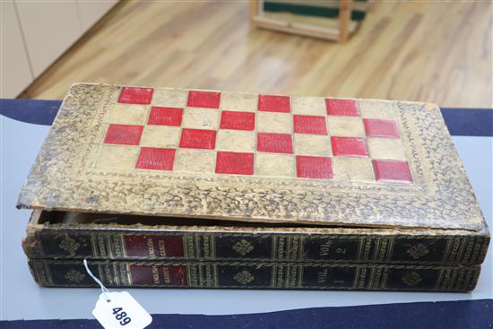 A Backgammon / chess board with stained ivory pieces